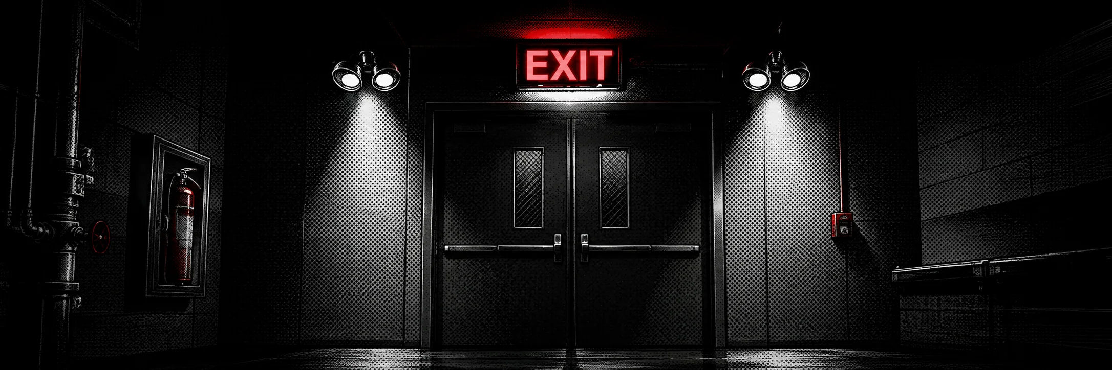Emergency exit doors under an illuminated exit sign with emergency lights either side